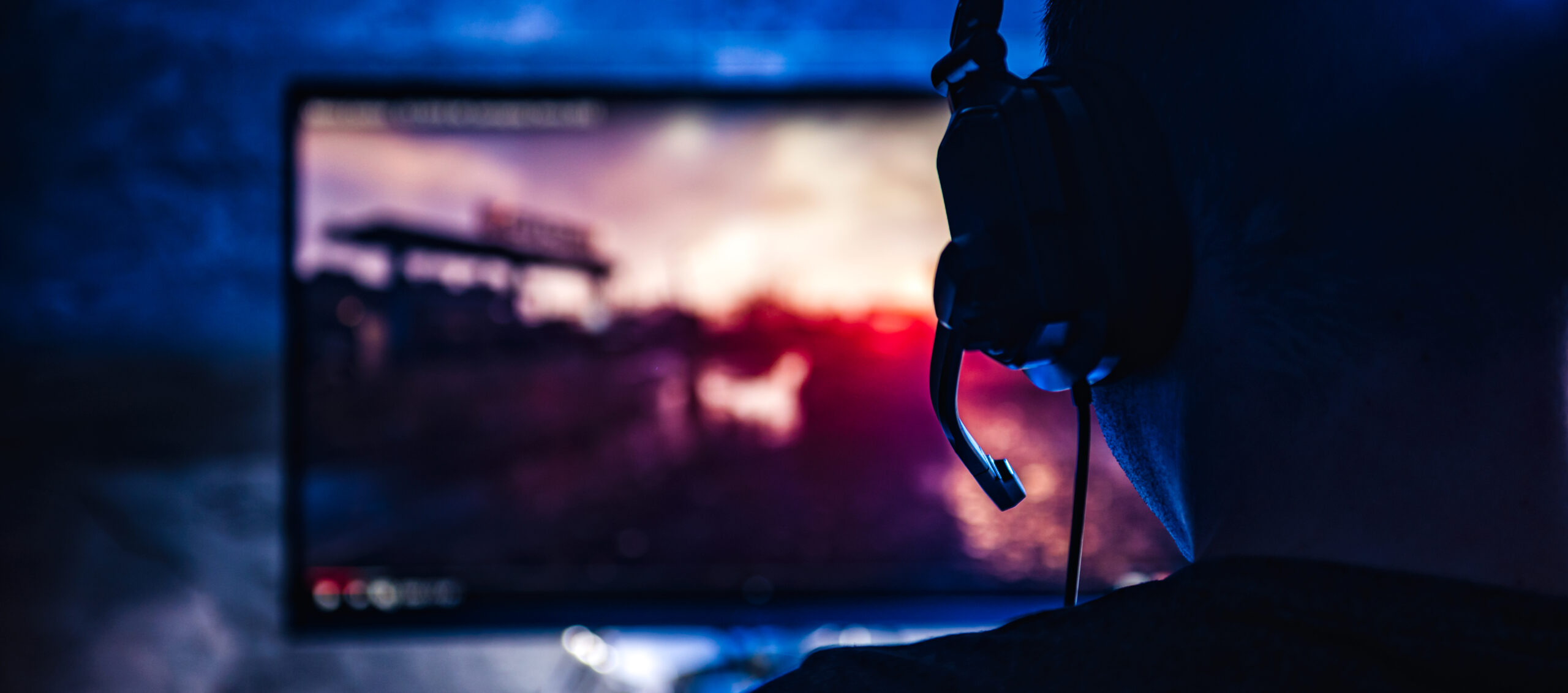 tik tok 3d photo of the back of a young person on their computer gaming with a headset on