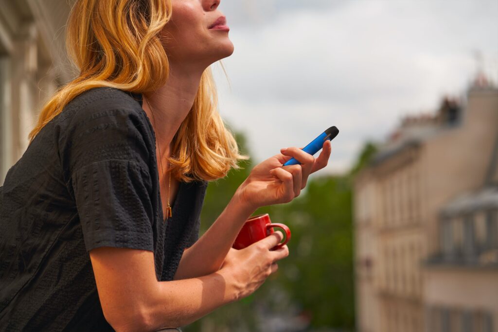 Woman holding a disposable vape